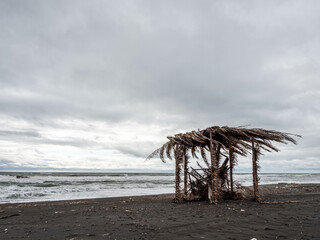 Abandoned beach hut in a melancholic atmosphere on a gloomy shore