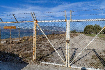 Fototapeta premium Rusted fence at the Lechaion basilica ruins, Korintos, Greece