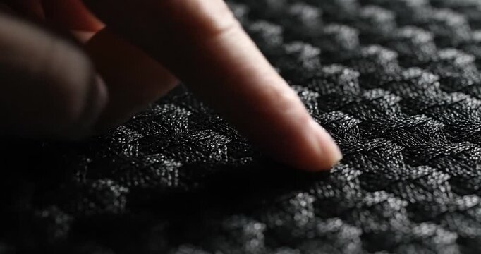 Close-up of finger on fabric texture.
