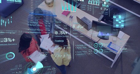Reviewing team members wearing red, white, yellow tops in office, examining papers and AR charts