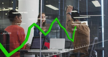 Discussing team in business attire viewing green financial graph overlay in glass room with laptops © vectorfusionart