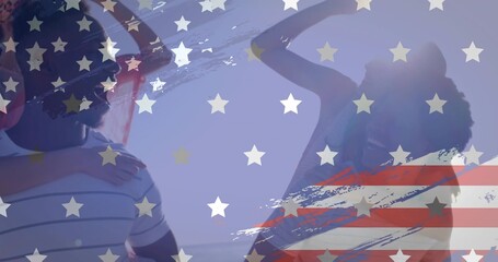 Cheering four pals hugging at beach, with sunglasses, striped tee and American flag overlay