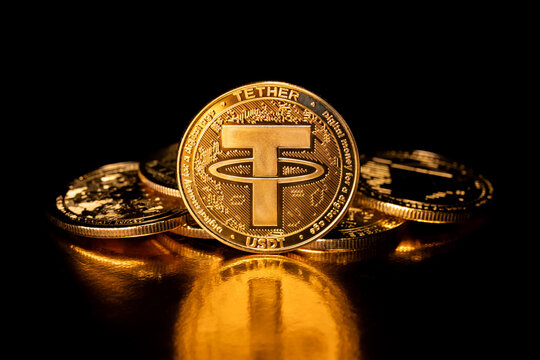 Kyiv, Ukraine - October 18, 2025. Tether USDT cryptocurrency and gold coins. Macro photography. A USDT coin isolated on a black background. Gold coins with a Tether coin in front of it. Cryptocurrency