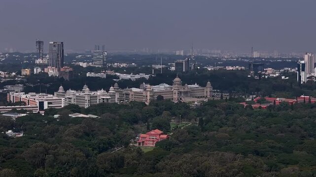 Aerial view of Vidhana Soudha government building surrounded by lush trees in Bengaluru
