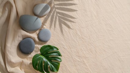 Zen Stones and Monstera Leaf on Linen &mdash; Minimalist Wellness Flat Lay with Natural Light & Copy Space