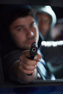 Gun, threat and thief for danger, violence and hijacking for robber hostage. Crime, corruption and man with illegal weapon for criminal, gangster or hitman with firearm aim for murder or homicide