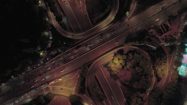 Aerial Highway Overpass at Night with Traffic and Trees