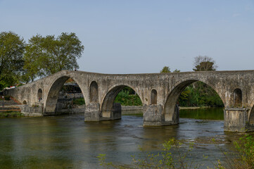 Fototapeta premium Old Stone Bridge over the River in Arta, Greece