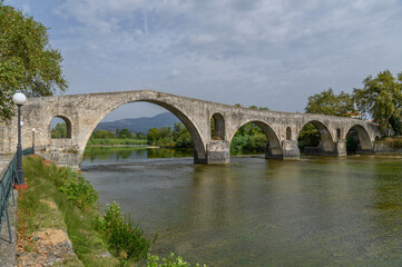 Fototapeta premium Old Stone Bridge over the River in Arta, Greece