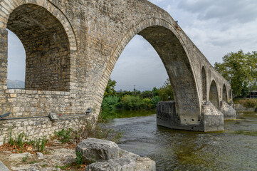 Fototapeta premium Main Arch of the Bridge of Arta above the River, Greece