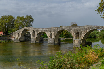 Fototapeta premium Old Stone Bridge over the River in Arta, Greece