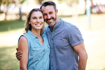 Happy, hug and portrait of couple in nature for bonding, care and love in marriage at park. Smile,...