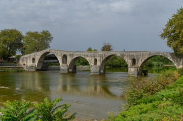 Fototapeta premium Old Stone Bridge over the River in Arta, Greece