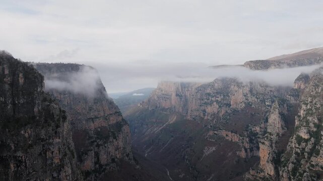Misty cliffs of Vikos Gorge in Epirus Greece, establshing natural landscape backdrop