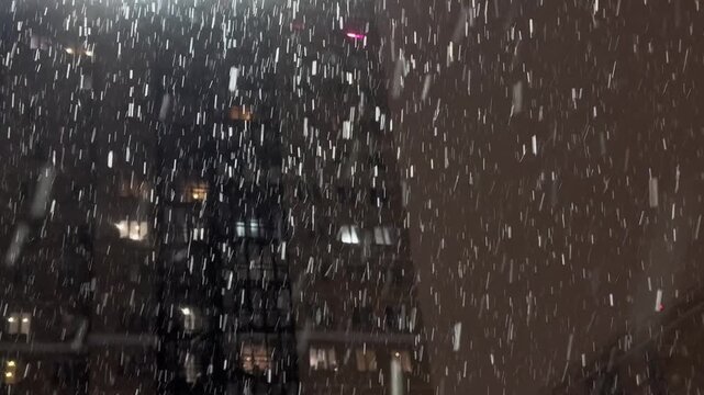 Street light illuminating falling snow during snowstorm at night. Realistic falling snow effect against a dark night sky, ideal for compositing winter scenes, creating a serene and magical atmosphere.