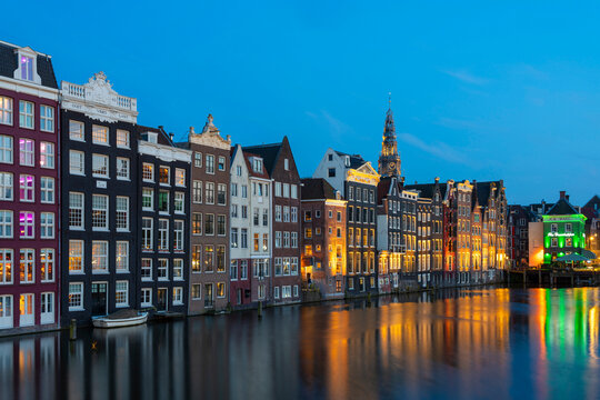 Dancing houses near tower of Oude Kerk Amsterdam Church at twilight, Damrak, Amsterdam, Netherlands