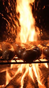 Juicy sausages cooking over open flames with intense fire and smoke effects