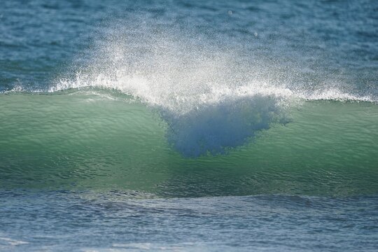 Ocean Wave Breaking with Water Droplets and Blue Gradient Texture