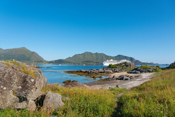 Cruise ship off the coast near Gravdal. The distinctive Lofoten mountain range behind.. Lofoten in Norway.