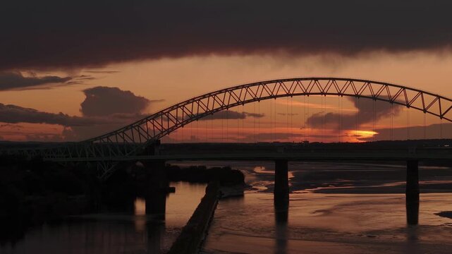 Liverpool, Merseyside, UK, September 09, 2025; aerial 4K video footage of the Silver Jubilee Bridge and Britannia Railway Viaduct over the River Mersey and Manchester Ship Canal, Runcorn, Merseyside