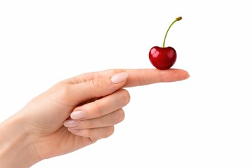 Studio photo of a red cherry balanced on a fingertip with the stem pointing upward