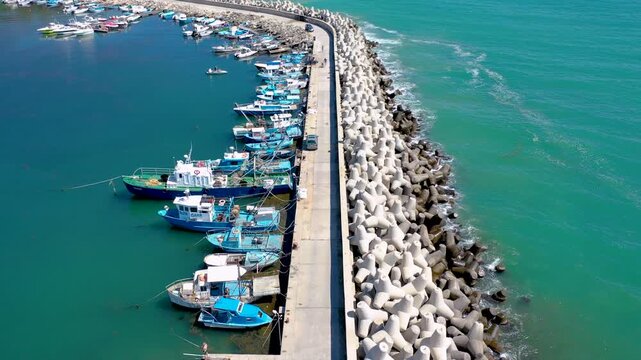 Drone 4k video of boats along dyke in port of Byala town on the Black Sea shore in Bulgaria