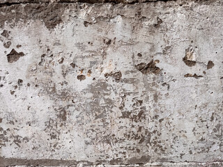 Obraz premium Old weathered white painted wall with peeling paint and exposed concrete surface texture