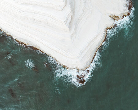 Aerial view of dazzling white cliffs meet the turquoise sea, Scala dei Turchi, Sicily, Italy.