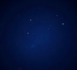 Fototapeta premium Dark blue background with scattered bright light particles, star-like shimmer, high resolution