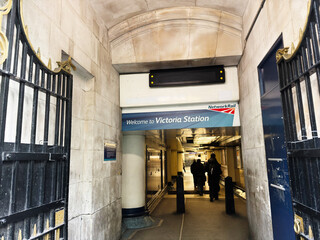Fototapeta premium Welcome to Victoria Station entrance at London Network Rail with travelers entering the hall