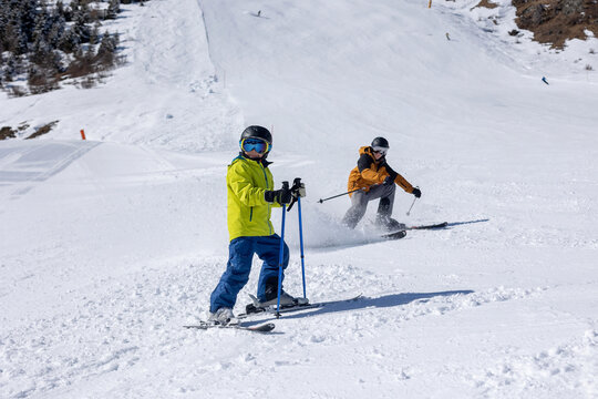 Happy family with children, school kids in winter ski resort, skiing winter time