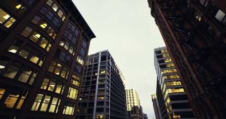 Fototapeta premium glassclad modern towers catching morning light with reflective facades, sleek steel geometry and calm plaza below, minimalist corporate tone and clean urban
