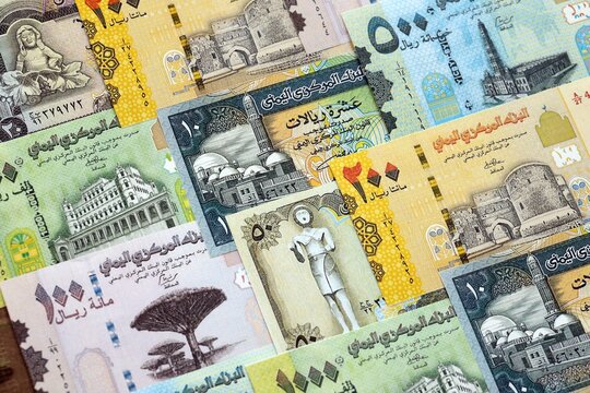 Yemeni rial paper banknotes pile on table. Yemen YER currency money bills in big amount. Concept of economics, taxation and banking in Yemen