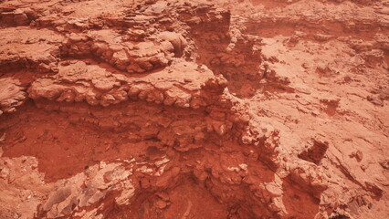 Fototapeta premium This breathtaking scene captures the intricate textures of red rock formations under a warm sunset glow. The rugged terrain invites adventurers to explore its natural wonders.