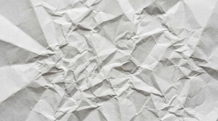 Obraz premium Abstract texture of crumpled white paper with shadows and highlights, close-up