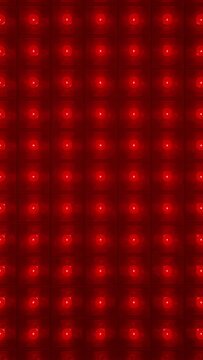 Vertical video: Powering LED panel cycling light against wall, with grid diodes shifting color