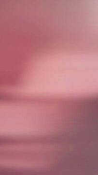 Vertical video: Shifting blurred pink surface showing camera focus drift in close up, lighter patch