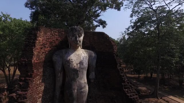 Ancient standing Buddha statue at Wat Phra Si Iriyabot, Kamphaeng Phet Historical Park, Thailand.