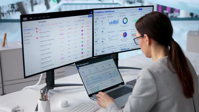 Young Woman Using A Laptop For Cybersecurity Risk Assessment