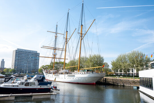 Harbor in Ostend, Belgium with big beautiful ship and yachts, buildings, sea.