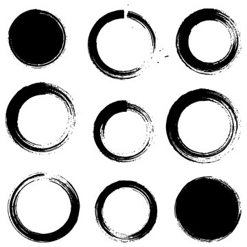 A set of circular graphic elements made in the style of rough brush strokes, prints, and splashes. Includes both solid textured circles and open rings in the enso aesthetic. Vector illustration.