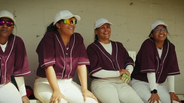 Baseball teammates share laughter in the dugout