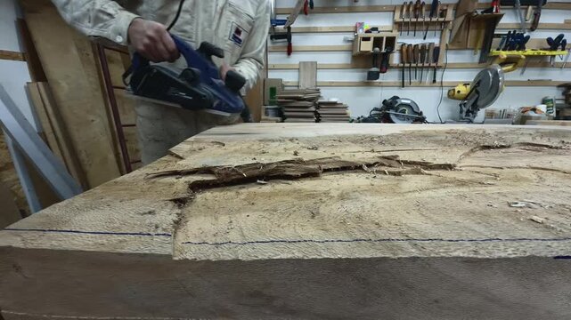 Authentic Faceless Maker Driving Unstoppable Momentum on Raw Timber Slab Low Angle Tracking Shot in Modern Workshop