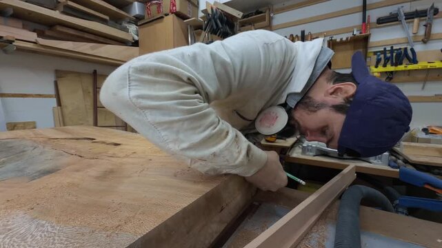 Authentic Millennial Maker Unmasked Drawing Precise Layout Line on Sustainable Timber Slab Close Up Tracking Shot