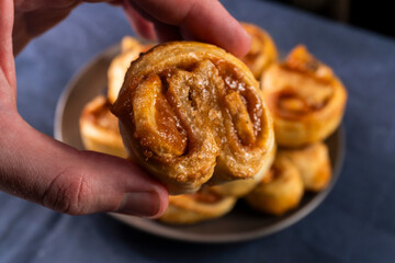 Freshly baked banana caramel puff pastry rolls on a baking sheet. Pastry. Dessert © Denis