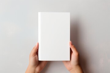 Holding paper white book.