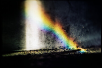 a blurry photograph of rainbow-like light in the dark, in the style of tarkovsky's polaroid photography.