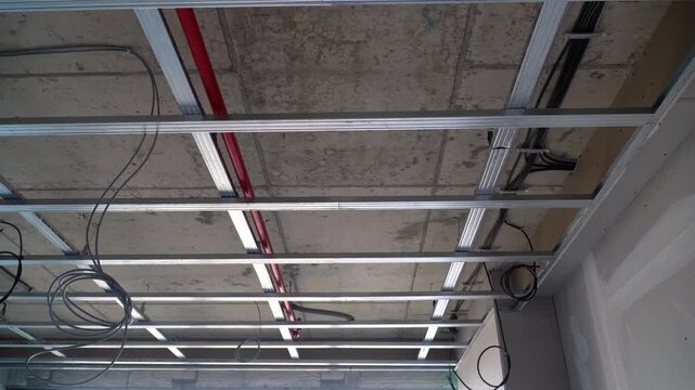 Aluminum metal substructure grid for suspended ceiling installation, building interior, construction process.