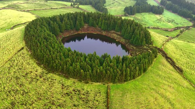 drone shot of crater lake on Sao Miguel, the Azores islands, Lagoa do Pau Pique in Azores, Portugal, travel in Portuguese islands