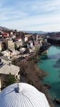 Drone aerial view of Stari Most (Old Bridge) and Koski Mehmed Pasha Mosque in Mostar, Bosnia and Herzegovina